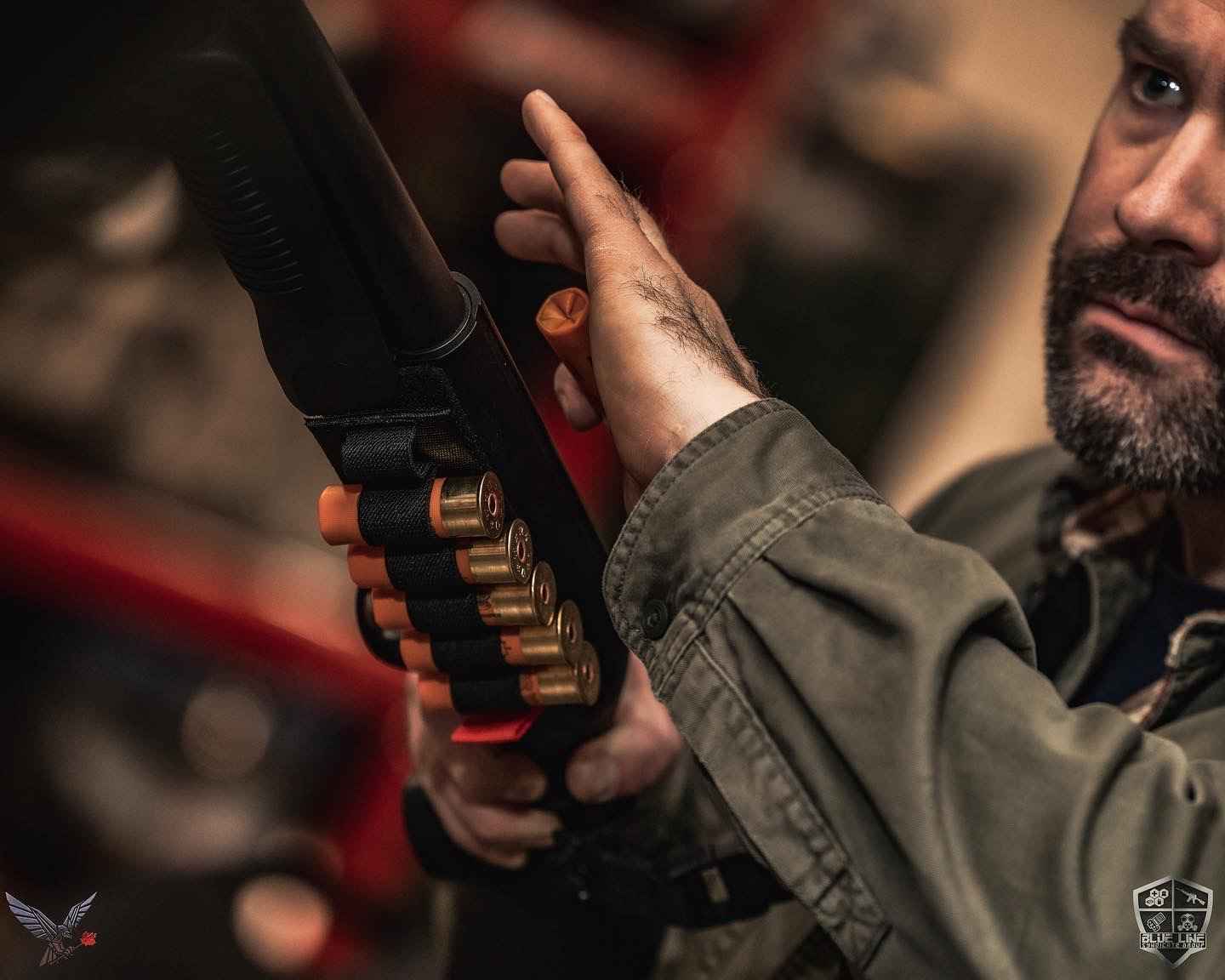 Instructor loading shells into a shotgun