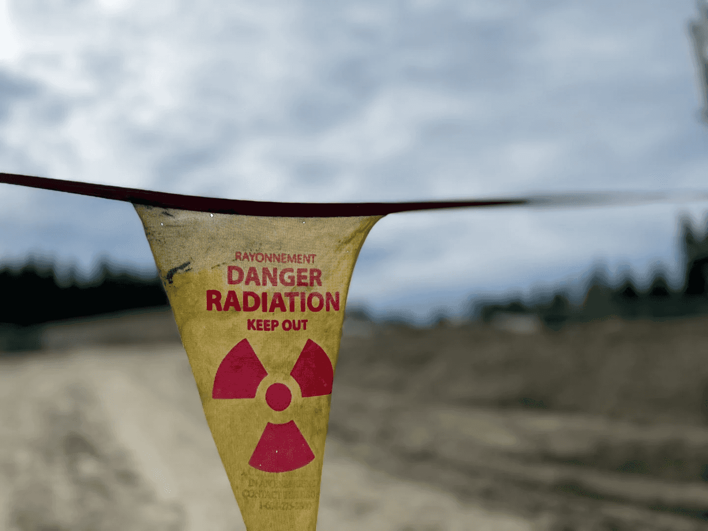 Radiation danger flag strung across a rural access road