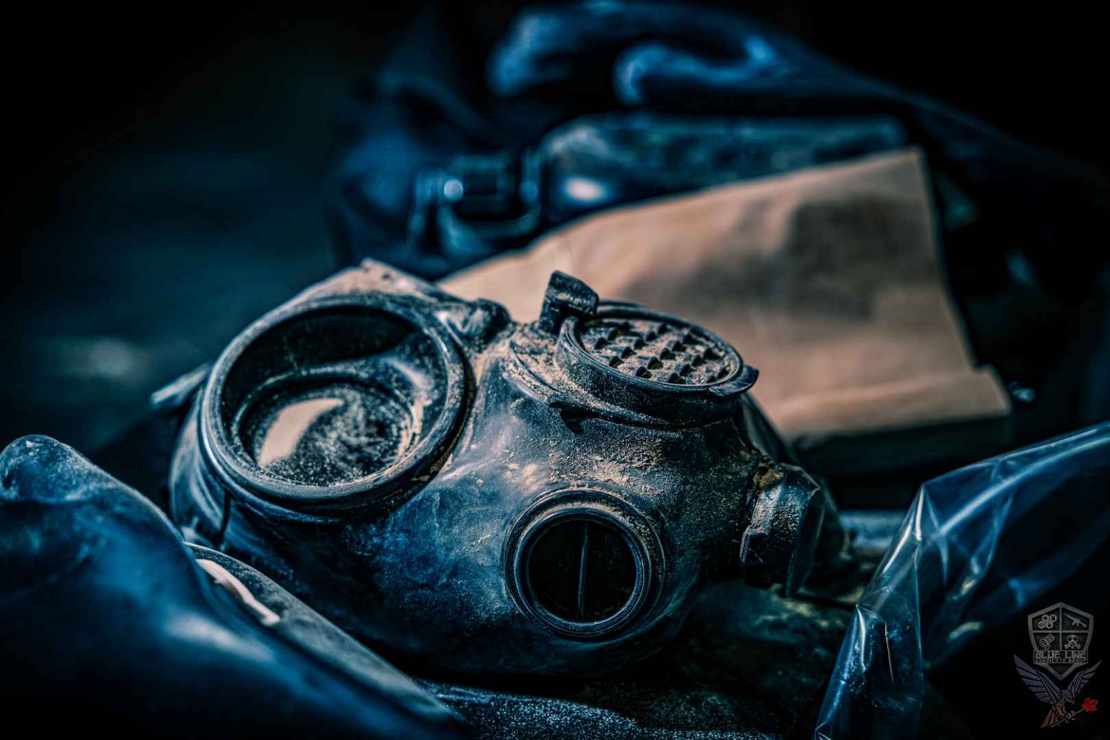 Respirator mask and filters on a dark surface