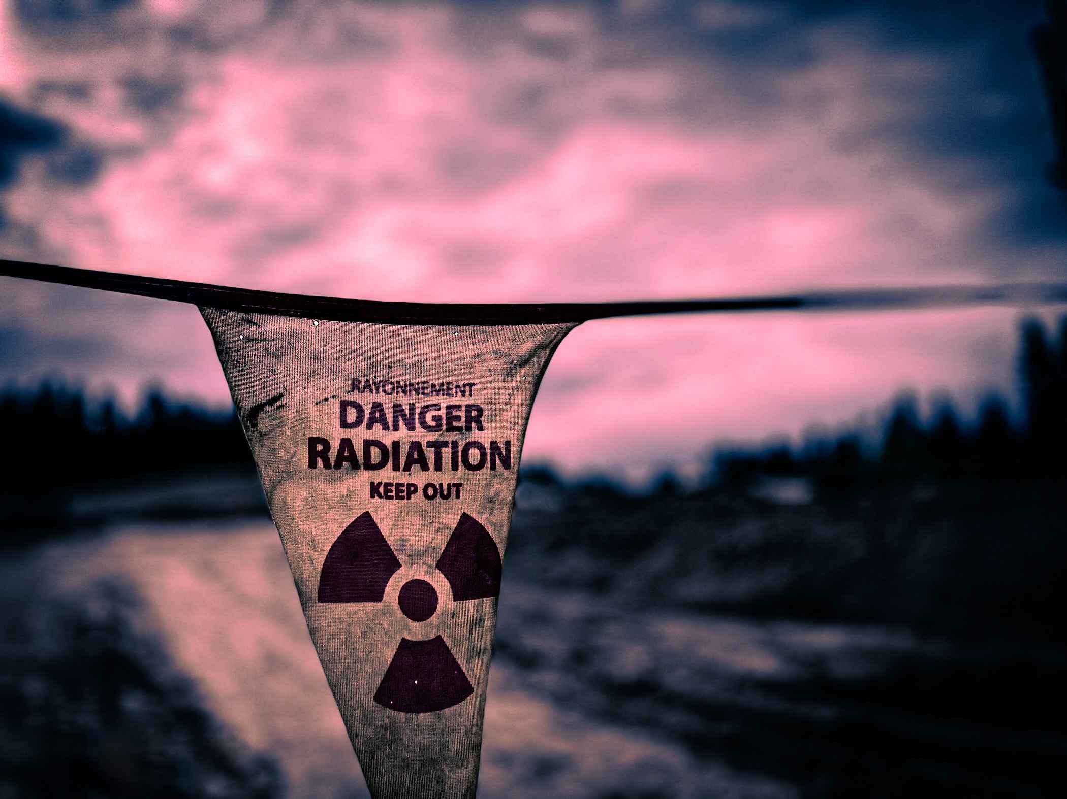 Radiation danger flag against a dusk sky