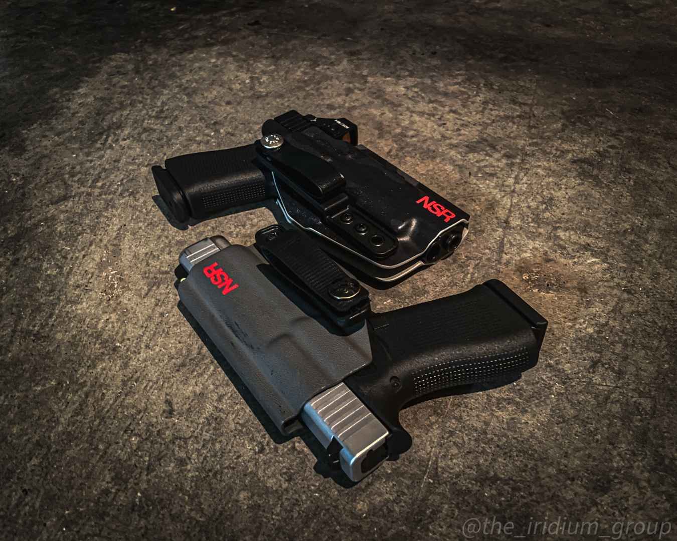 Holstered handgun lying on a concrete floor