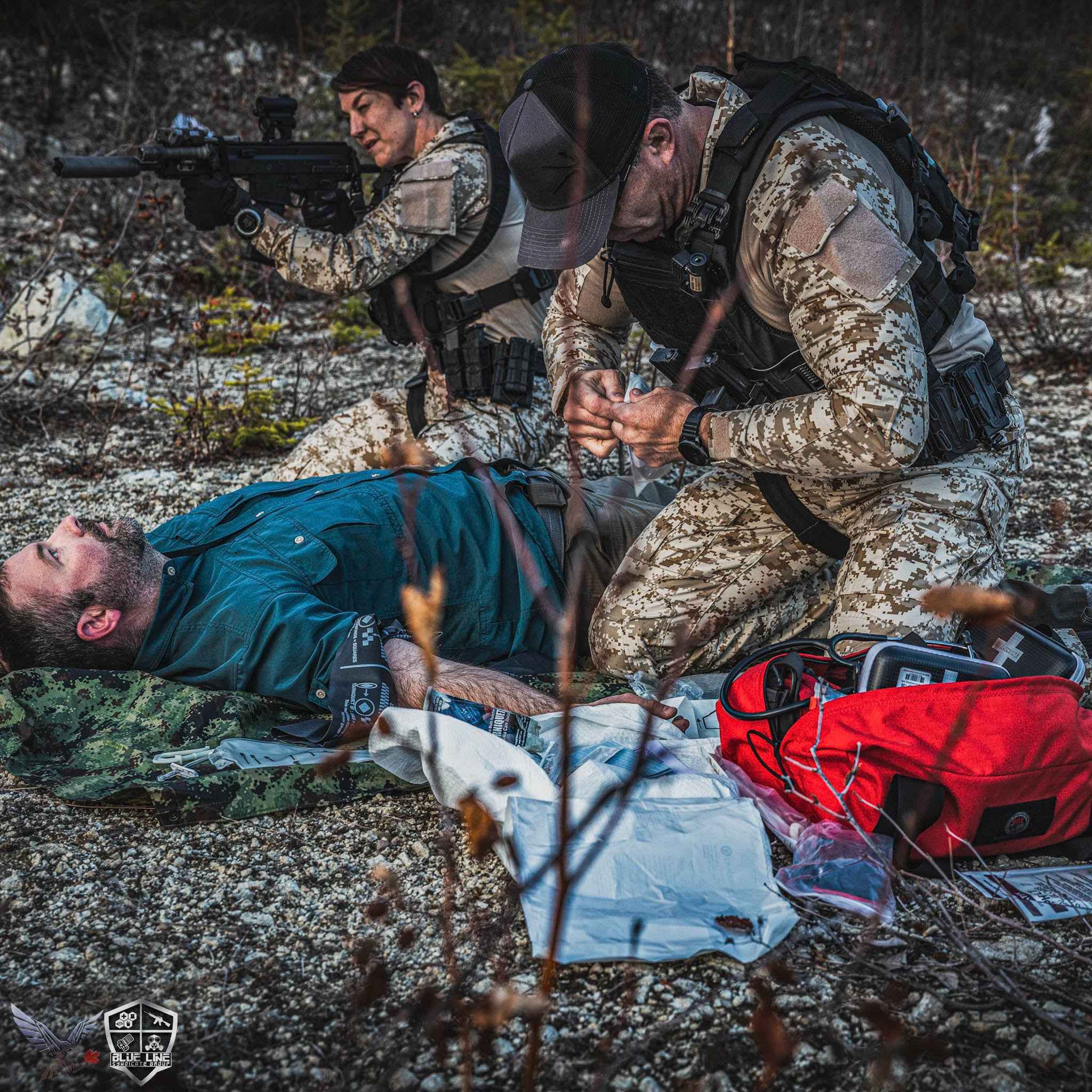 Students in the field treating a simulated casualty with a trauma kit