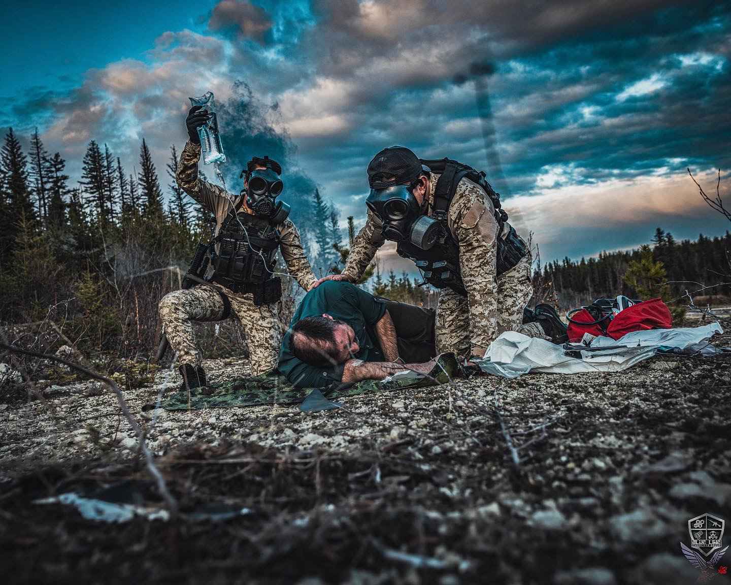Students kneeling in the field to treat a simulated casualty